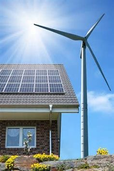 a solar panel on top of a house next to a wind turbine