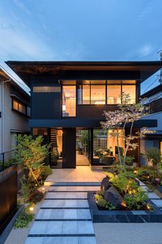 a modern house is lit up at night