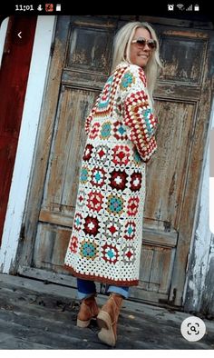 a woman standing in front of a wooden door wearing a crocheted granny outfit