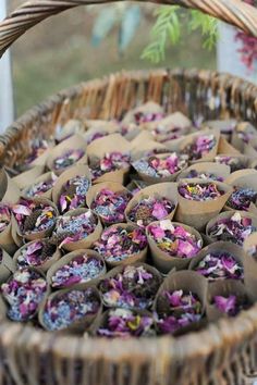 a wicker basket filled with lots of purple flowers