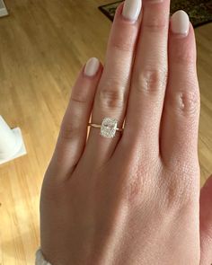 a woman's hand with a diamond ring on it