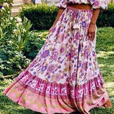 The Gorgeous Buttercup Maxi Skirt In Meadow, With Its Other-Worldly Drape & Stunning Spell Signature Print, Has A Distinctly 70’s Vibe & Takes You Right To The Heart Of Luxe Bohemia. Featuring A Full Elastic Waist With An Adjustable Tie, Brass Beads & Tassels, The Floaty & Nostalgic Sprawling Florals Are Perfectly Framed With A Gathered Frill Hem & Placement-Printed Contrasting Borders, For Vintage Charm Coupled With A Flattering Modern Fit. Crafted In Color-Popping Rayon Fujet, This Expressive Beads Tassels, Brass Beads, Feminine Beauty, Signature Print, Beaded Tassels, Modern Fit, No Frills, Pink Purple, Borders