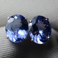 These tanzanite earrings feature a well matched pair of genuine earth mined tanzanite. The earrings are made of solid sterling silver. The tanzanite are described as follows:Natural Zoisite/TanzaniteOrigin: Merelani, Northern TanzaniaCarat Weight: 3.22cts + 3.72cts = 6.94cts total weightShape: Oval Mixed CutMeasurements: 11.11mm x 8.93mm x 4.98mm and 11.01mm x 9.01mm x 5.31mm*** Tanzanite Studs, Tanzanite Earrings, Oval Cut, Stone Jewelry, Stud Earrings, Sterling Silver, Stone, Silver, Gold