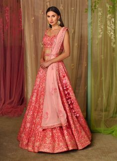 Editor's Note This set features a lehenga with thread and gota embroidered on printed silk with belt and embroidered organza dupatta Color: Pink Fabric: Silk, organza Sleeve: Sleeveless Neckline: Sweetheart Embroidery details: Gota and thread embroidery Component: Blouse, lehenga, belt and dupatta Lehenga length: 43" inches and blouse: 14" inches Occasion: Sangeet Care: Dry clean only About the Designer Shyam Narayan Prasad started his journey in the Indian Fashion Design Industry with a couture Lehenga Belt, Blouse Lehenga, Organza Sleeves, Embroidered Lehenga, Embroidered Organza, Organza Dupatta, Thread Embroidery, Silk Organza, Fabric Silk