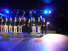 a group of men standing on top of a stage