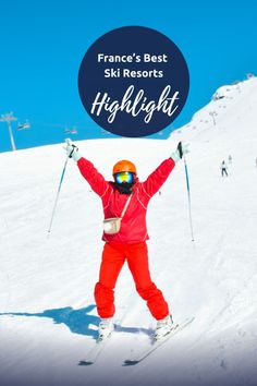 a person on skis holding their arms up in the air