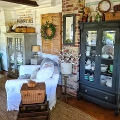 a living room filled with furniture next to a brick wall