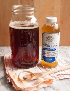 two bottles of liquid and scissors on a table