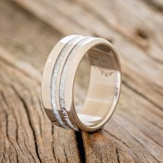 the wedding band is made from white gold and has silver inlays on it