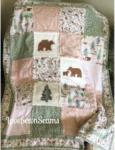 a baby quilt with bears and trees on it