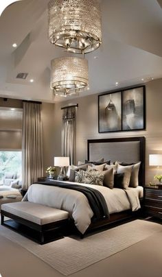 a large bed sitting under a chandelier in a bedroom next to a window