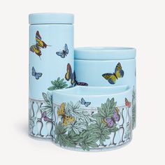 three blue dishes with butterflies painted on them