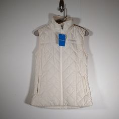 New With Tags Attached Ivory Cream White Color Puffer Quilted Vest Soft Plush Lining Inside Front Zipper Pockets Zipper Up Front High Neckline Size Xs Approximate Measurements: Pit To Pit = 17 Inches Across Length From Top Of Shoulder To Hem = 24.5 Inches White Sleeveless Outdoor Outerwear, Cream Sleeveless Outerwear For Spring, Sleeveless Cream Outerwear For Fall, Vest Puffer, Cream White Color, Quilted Vest, Columbia Jacket, Columbia Jackets, Ivory White