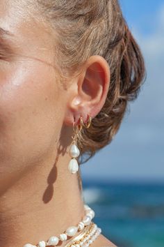 These asymmetrical carved Pikake and Baroque Pearl Earrings make beautiful simple statements. Seemingly plucked straight from the ocean, the luminous, organic white pearls sway and illuminate in the light. Wear these unique pearl, pikake, and gold earrings for a modern upgrade.✦ DETAILS ✦✧ Name: Huali - (hoo A lee) - Pure, bright, gleaming.✧ 14kt Gold Filled.✧ Genuine Freshwater Baroque Pearls.✧ Carved Mother of Pearl Pikake Flowers.✧ All Ke Aloha Jewelry pieces come packaged thoughtfully, beaut White Baroque Pearl Single Hoop Earring, Single White Baroque Pearl Hoop Earring, Delicate White Hoop Earrings With Pearl Drop, White Dainty Baroque Pearl Earrings, Dainty White Baroque Pearl Earrings, Delicate White Hoop Earrings With Pearl Charm, Everyday White Baroque Pearl Earrings, Baroque Pearl Earrings, Baroque Pearls