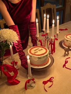 a woman sitting in front of a cake with candles on it