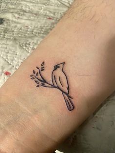 a small bird sitting on a branch with leaves around it's neck tattoo design