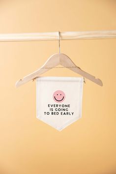 a baby bib hanging from a clothes line with a hanger attached to it