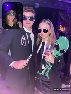 a man and woman dressed up as aliens