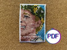 a cross stitch pattern with the image of a man's face on it