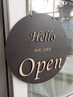 a sign that says, hello we are open