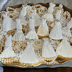 wedding cookies are arranged on a gold platter