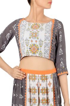 Grey printed crop top with all-over orange printed motifs. Comes with a printed skirt. 
Components: 2
Pattern: Printed
Neckline: Scoop neck
Sleeve length: Three-quarter sleeves
Fabric: Crepe
Color: Grey - Aza Fashions Multicolor Printed Cropped Crop Top, Multicolor Printed Cropped Top, Printed Multicolor Cropped Top, Fitted Bohemian Orange Crop Top, Orange Digital Print Sets For Spring, Fitted Choli With Printed Motifs For Summer, Spring Orange Digital Print Sets, Fitted Cropped Multicolor Sets, Multicolor Cropped Fitted Sets