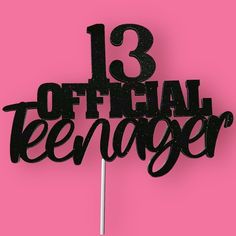 a black cake topper that reads 13 official teenager