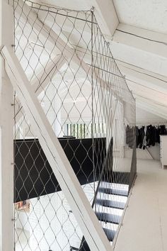 the interior of a building with white walls and metal railings