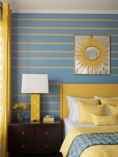 a yellow and blue bedroom with striped walls