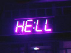 a neon sign that reads hell on the side of a building