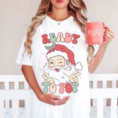 The cutest Christmas Maternity shirt! Comfort Colors introduces its garment-dyed t-shirt; a fully customizable tee made 100% with ring-spun cotton. The soft-washed, garment-dyed fabric brings extra coziness to your wardrobe while the relaxed fit makes it an excellent daily choice. The double-needle stitching throughout the tee makes it highly durable while the lack of side-seams helps the shirt retain its tubular shape. .: Made with medium fabric (6.1 oz/yd² (206.8 g/m consisting of high quality Christmas Maternity Shirts Vinyl, Cute Christmas Shirts Vinyl Pregnant, Pregnant Christmas Shirts, Pregnant Christmas Pajamas, Christmas Shirts For Pregnant Women, Christmas Maternity Shirt, Christmas Maternity, Maternity Shirt, Christmas Pregnancy