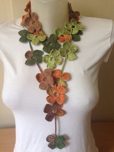 a crocheted flower necklace on a mannequin