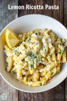 lemon ricotta pasta in a white bowl topped with parmesan cheese