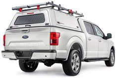 the back end of a white ford f - 150 pickup truck with an aluminum roof rack