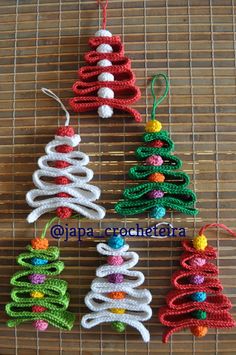 crocheted christmas tree ornaments on a bamboo mat