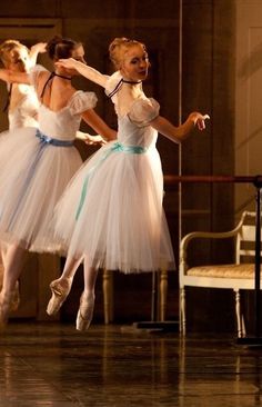 three ballerinas in white tutus and blue bows