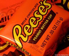 reese's peanut butter cups are stacked on top of each other in an orange wrapper