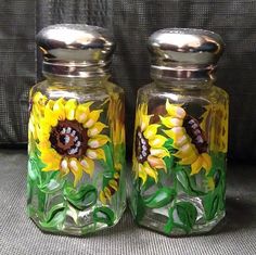 two glass jars with sunflowers painted on them