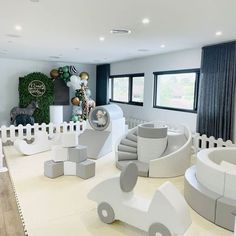 an indoor play area with white furniture and decorations