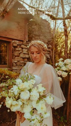 a woman holding a bouquet of white flowers