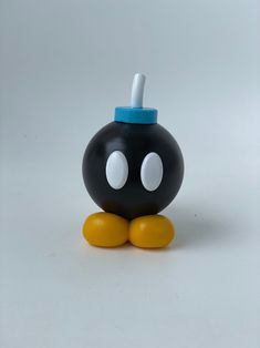 a black and yellow toy with white dots on it