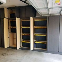 an empty garage with several storage bins in it