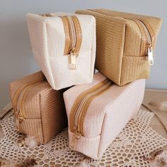 three pieces of luggage sitting on top of a doily