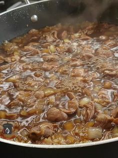 a large pot filled with food cooking on top of a stove