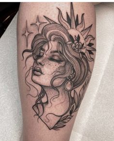 a woman's face with flowers and leaves on her thigh, done in black ink