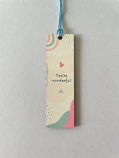 a tag with the words you're wonderful hanging from a string on a white surface