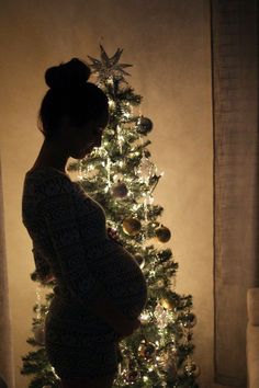 Pregnant By Christmas Tree, Maternity Photography Christmas Lights, Bump Picture In Front Of Christmas Tree, Pregnancy Photo In Front Of Christmas Tree, Pregnancy Silhouette Pictures Christmas, Pregnant Belly In Front Of Christmas Tree, Pregnant In Front Of Christmas Tree, Baby Bump Christmas Tree, Pregnant Belly Christmas Tree