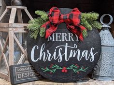 a merry christmas sign is displayed on a mantle with other holiday decorations and decor items