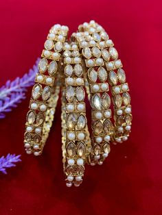 Polki bangles with pearl details. Comes in a set of 4. Pearl Bangle For Wedding, Elegant Festive Pearl Bangle Bracelet, Festive Pearl Bangle Jewelry, Elegant Festive Pearl Bracelets, Polki Bangles, Pearl Details, Bangle Bracelets, Jewelry Bracelets, Bangles