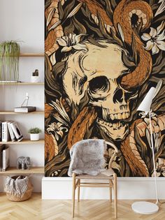 a wall mural with a skull, snake and flowers on it in a living room